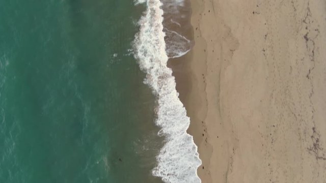 Cairns beach DRONE aerial view. Turquoise ocean sea, white sand, road trip. Dramatic birdseye view from above beach coast. Travel, sun, holiday, vacation, paradise. Shot in Queenstown, Australia.