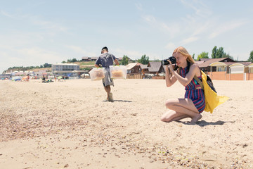 Woman photographer on the beach.