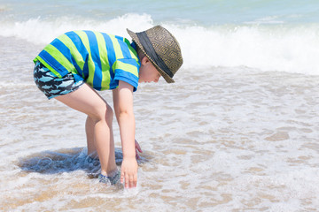 Little boy in a hat on the sea, the ocean. The concept of rest, vacations.