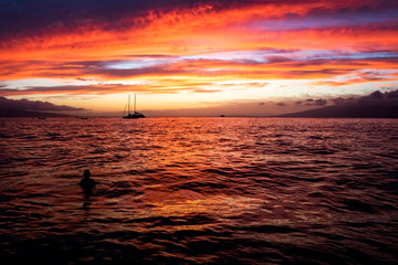 Orange and Purple Sunset over Sea with Islands in Distance