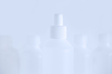 White plastic a bottle with disinfectant. Blurred background.