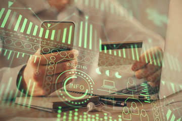 Obraz premium Double exposure of man hands holding a credit card and tech theme drawing. Technology in E-commerce concept.