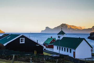 Scenic landscape view of traditional historic houses/buildings with grass (turf) roof in the Gjógv village, Eysturoy Island. Tourist popular attraction/place in Faroe Islands (Denmark)