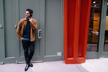 Smiling handsome young man talking on phone