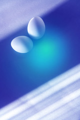 Two eggs on a blue-turquoise gradient background.
