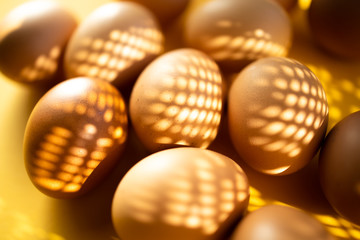 Group of fresh eggs on the table isolated on yellow background. Easter concept.