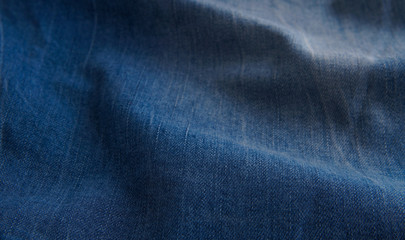 Naklejka premium blue denim background with scuffed and creases