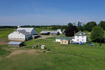 Fototapeta na wymiar Aerial Ohio Amish countryside farm barn laundry. Settled late 1700's as pioneer religious settlement. Old Amish Mennonite town. Rural order. Farming landscape. Old Amish Mennonite settlement.