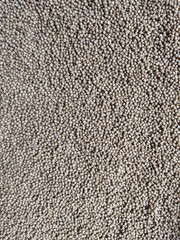 Fish feed, pet pellets texture background, top view