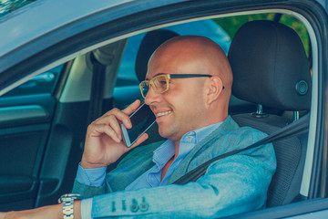 man using mobile phone while driving car to work. Risky, reckless driver bad habits.