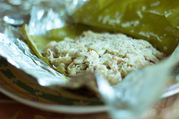 A shot of steamed Calamari  wrapped in banana leave