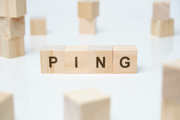 Modern business buzzword - ping. Word on wooden blocks on a white background.