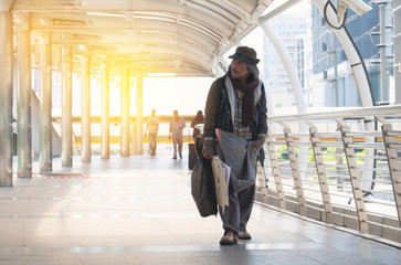 Homeless Asia man.He walking in town.He is very sadly and unhappy.poverty,despair,Photo Sympathetic and hope concept.