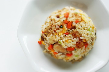 Chinese food, chicken and carrot fried rice on white plate