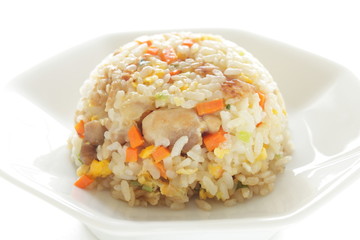 Chinese food, chicken and carrot fried rice on white plate