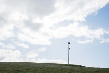 Fototapeta na wymiar Lanscape of mobile phone tower on farm land with sky and clouds in back ground