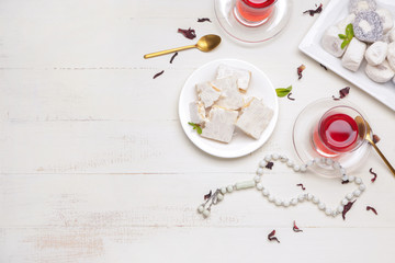 Tasty Turkish tea with sweets on table