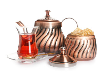 Tasty Turkish tea with sweets on white background