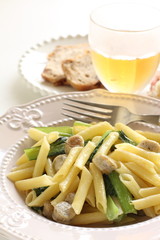 Italian food, penne and sausage with green leaf vegetable
