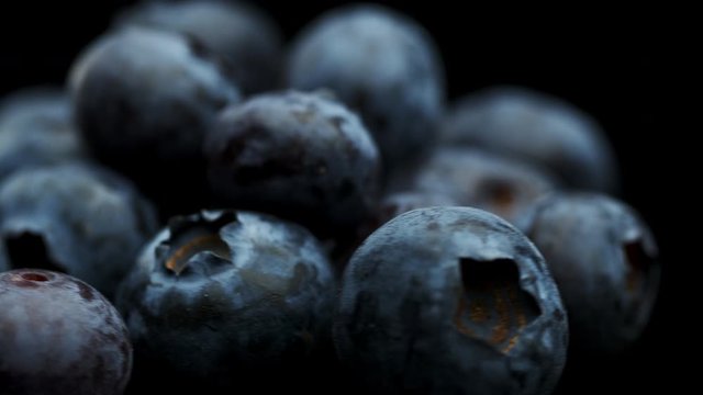 A group of blueberries rotating on a black background