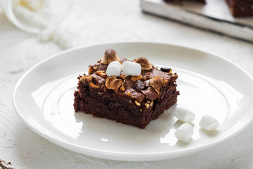 Chocolate brownie cake with marshmallows and nuts