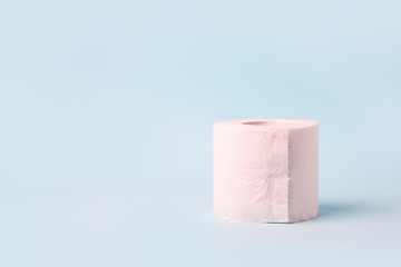 Toilet roll on blue background. Concept of lack of toilet paper in stores due to coronavirus, Covid-19, hygiene, panic. Copy space, deficit of sanitary set in supermarket