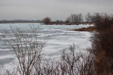 Fototapeta na wymiar Winter frozen waves of lake ice