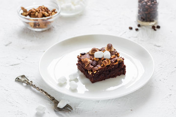 Chocolate brownie cake with marshmallows and nuts