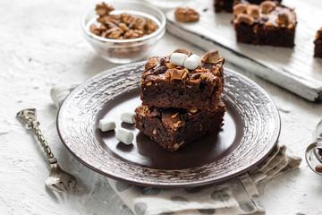 Fototapeta na wymiar Chocolate brownie cake with marshmallows and nuts