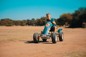 Happy Child on an open Go-Kart enjoying the outdoor sport activity. This was taken in South Africa.