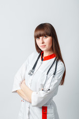 Smiling happy doctor pointing on blue background