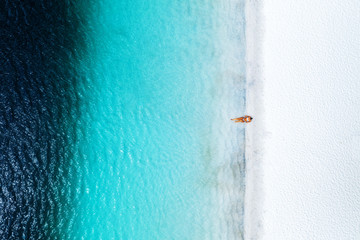 Alone swimmer in blue water Lake Mckenzie Fraser Island Queensland Australia 