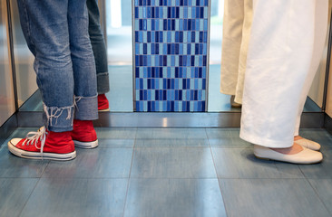 Women in an elevator with social distancing