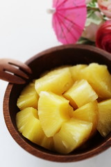 Canned food, pineapple in wooden bowl with copy space