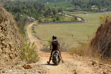 Man on scooter on gravel road, Lombok © Martina