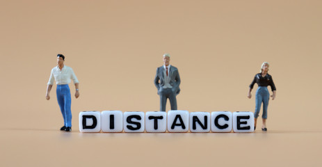 Cube with 'DISTANCE' text and miniature people.
