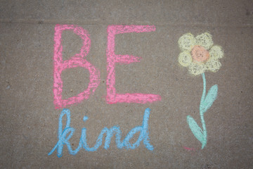 Be Kind words and a flower drawn with sidewalk chalk - temporary art