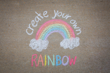 Create your own rainbow words with rainbow drawn with sidewalk chalk on the ground - temporary art