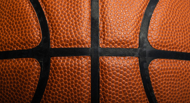 A close-up of a leather basketball on white