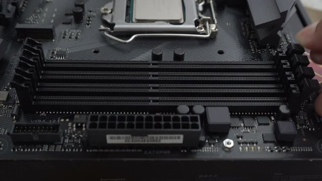 Removing random access memory RAM into modern black motherboard for PC or Server