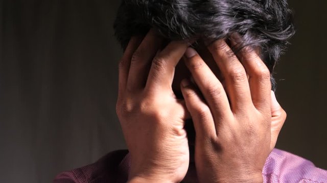 a man suffering headache and having a bad mood.