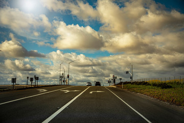 Intersection with large amount of blue sky and clouds