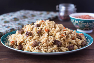 pilaf in a plate with a national pattern, Uzbek dishes, oriental cuisine
