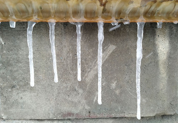 icicle on the street stone wall