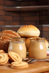 Milk dessert, cookies and bread rolls