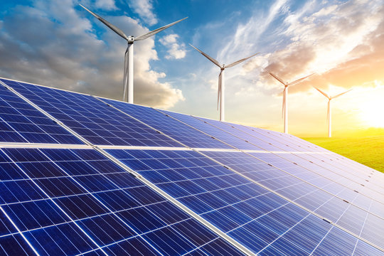 Solar panels with wind turbines in the setting sun,green energy.