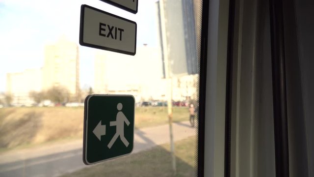 Information plate on the EXIT doors of the bus. Frame inside the bus while driving. Operation of public transport during quarantine.