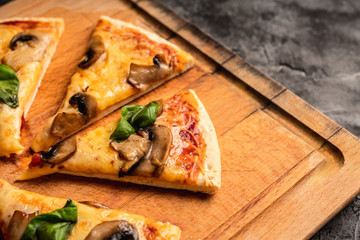 Freshly making pizza with mushrooms served on the rustic background. Selective focus. Shallow depth of field.