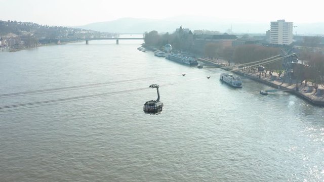Cable car Seilbahn  lift to the fortress ehrenbreitstein over the river rhine with a ship in Koblenz near Deusches Eck german corner panning drone aerial shot 4k 30p