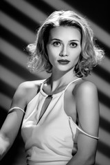 Hollywood retro portrait of beautiful elegant blonde woman with wavy hair
